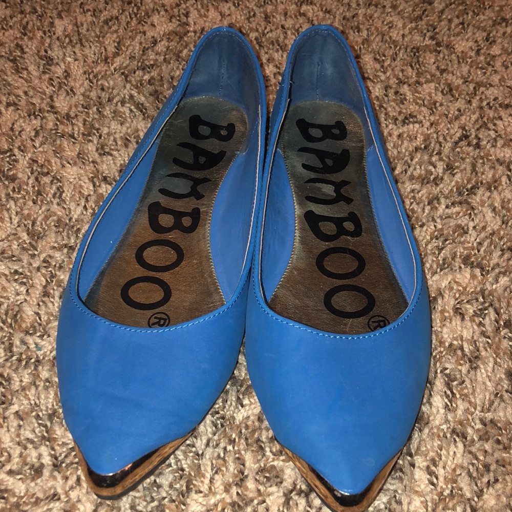 Blue flats with gold points.